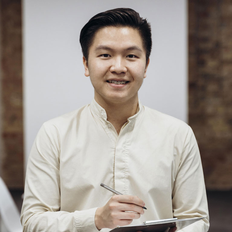 A man in white shirt holding a tablet.